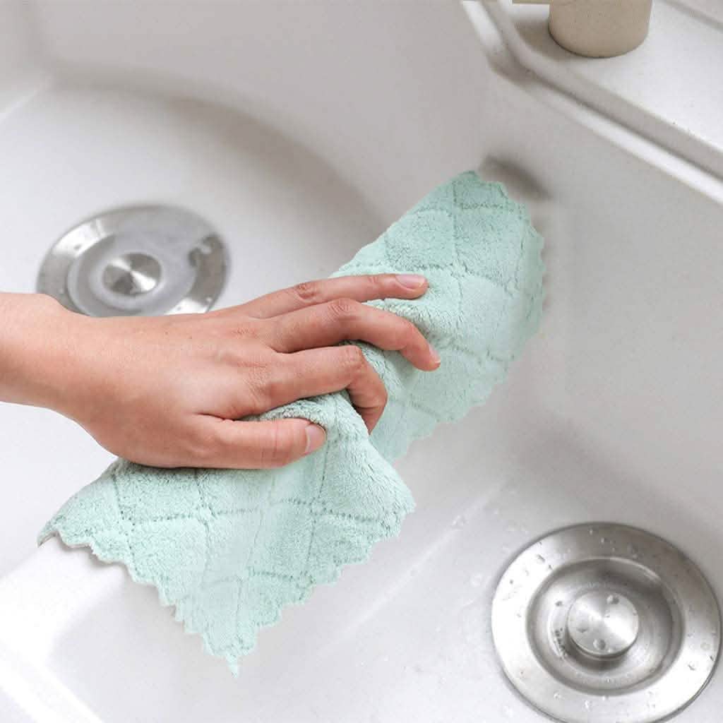Kitchen dish towel, mint green, held over a white sink