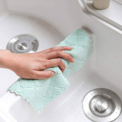 Kitchen dish towel, mint green, held over a white sink