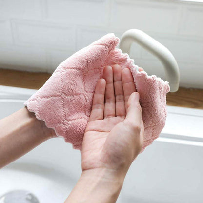 Kitchen dish towel, pink, held under running water