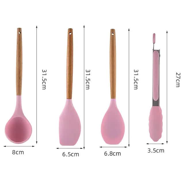 Pink silicone kitchen tools with wood handles, including ladle, spatula, and whisk
