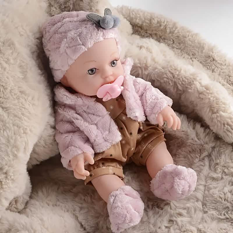 Cuddled pink plush baby doll in gray-ear hat and hood, brown star romper, pink pacifier.