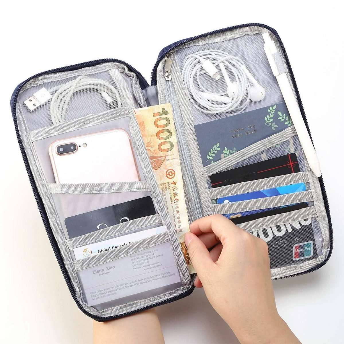 Travel passport wallet open with light gray interior, zip pockets, and banknote in sleeve