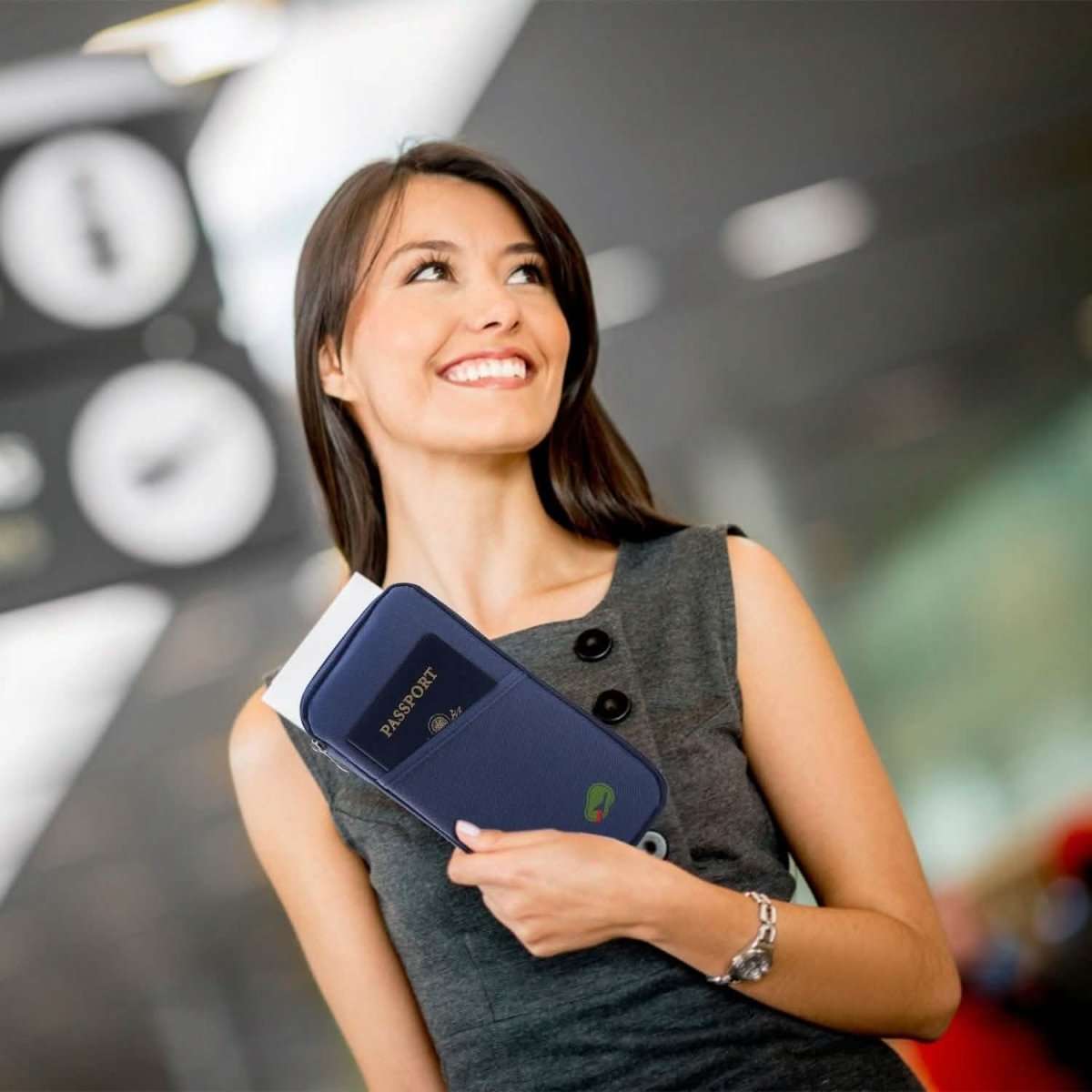 Blue travel passport wallet held in hand with passport-style front cover visible