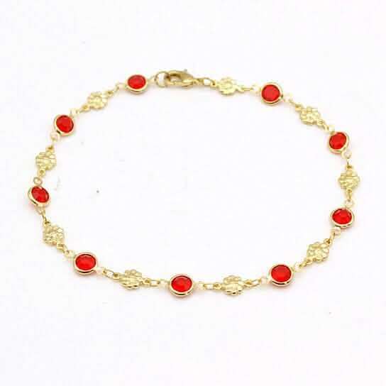 Gold-tone anklet bracelet with red crystal beads and small flower charms