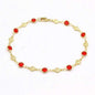 Gold-tone anklet bracelet with red crystal beads and small flower charms