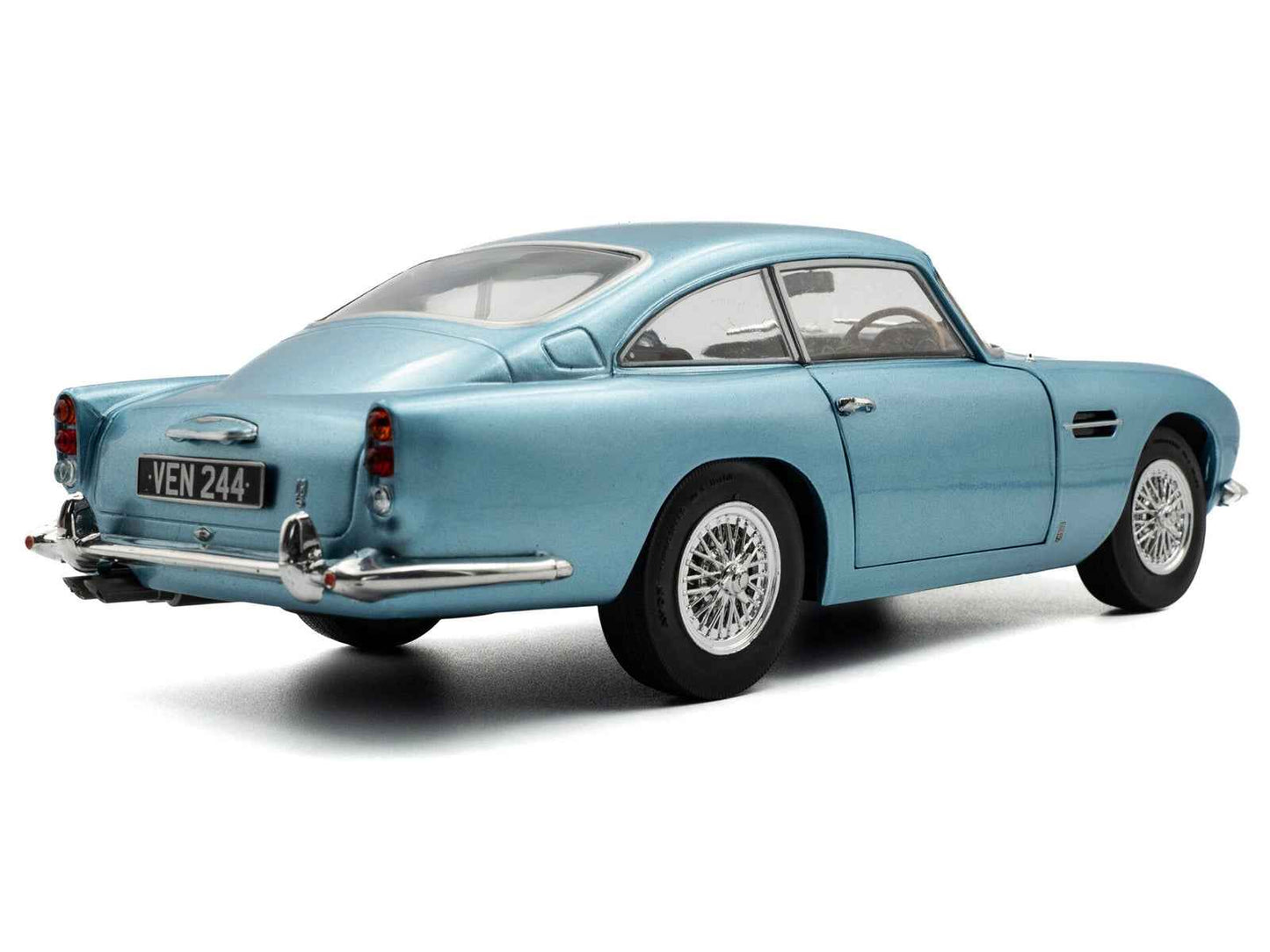 Light blue metallic RHD diecast coupe model car rear 3/4 view with chrome bumper