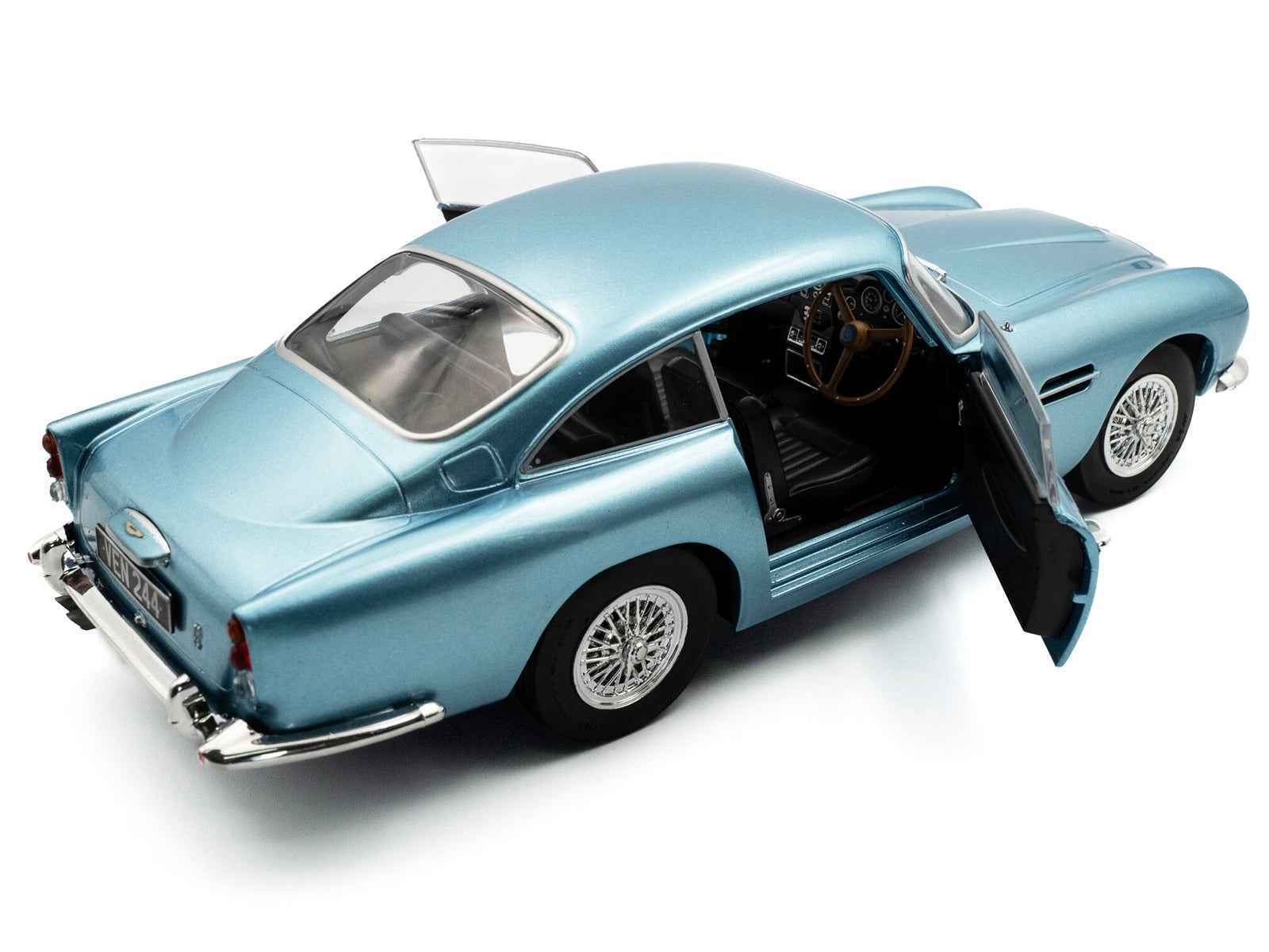 Light blue metallic RHD diecast coupe model with open passenger-side door