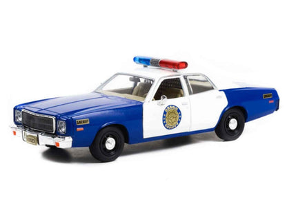 1/24 diecast police model car, blue and white with roof light bar, front 3/4 view