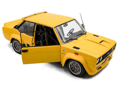 Yellow 1980 Fiat 131 Abarth diecast model car, front-left 3/4 view with detailed grille