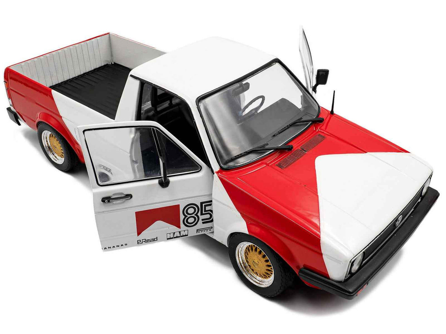 Red and white diecast pickup truck model, front angle with left door open