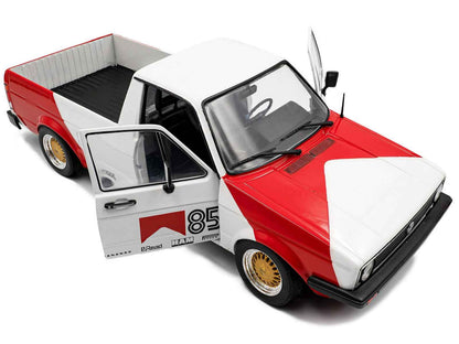 Red and white diecast pickup truck model, front angle with left door open