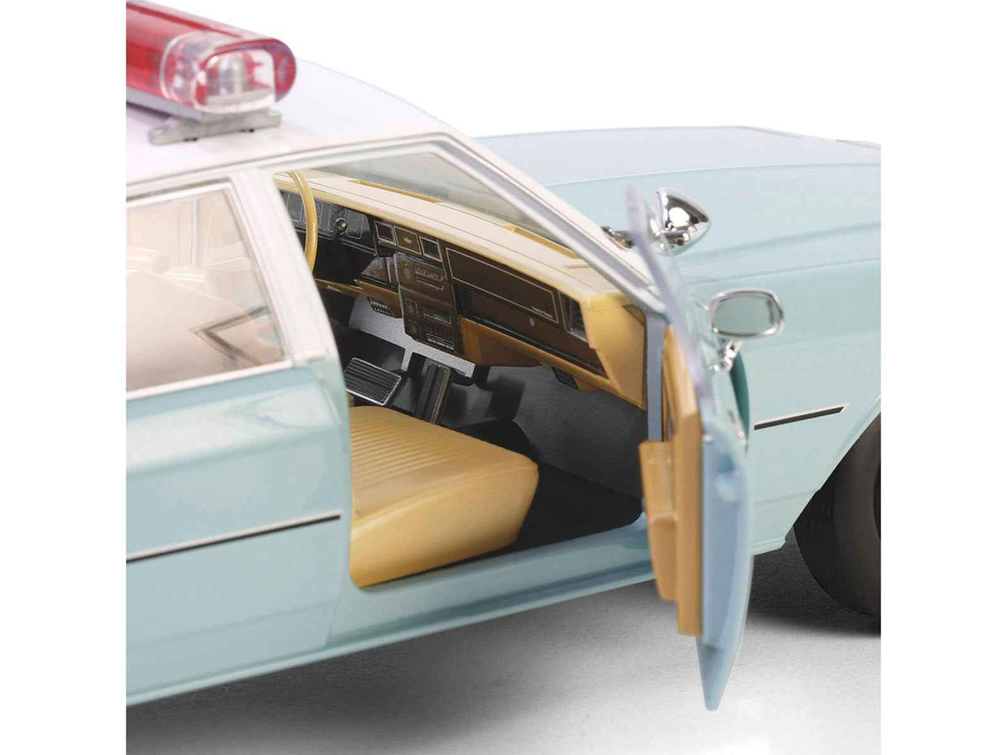Light green diecast police car with white top, open rear door with tan seats visible