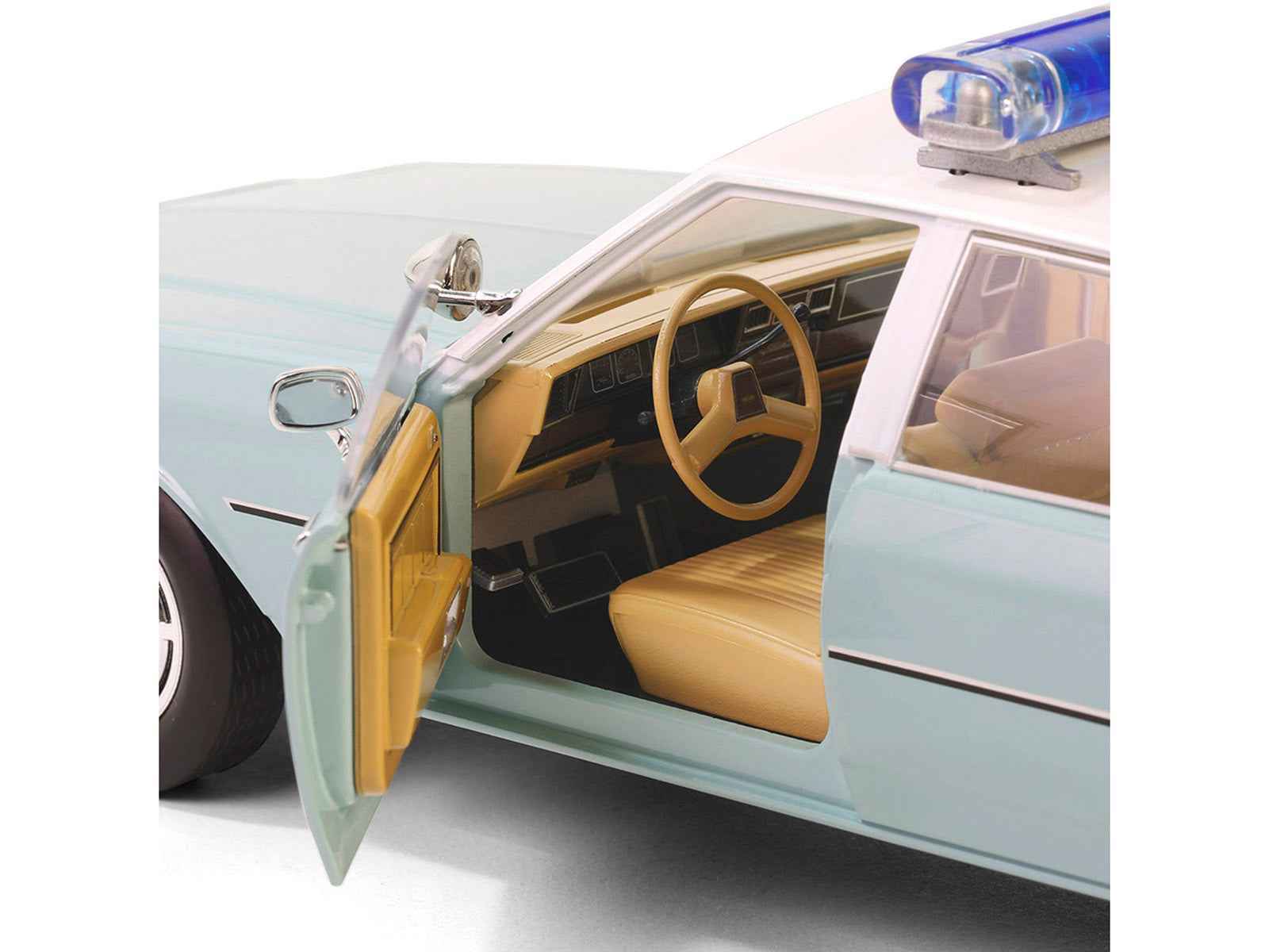 Light green diecast police car with white top, open front door showing tan interior