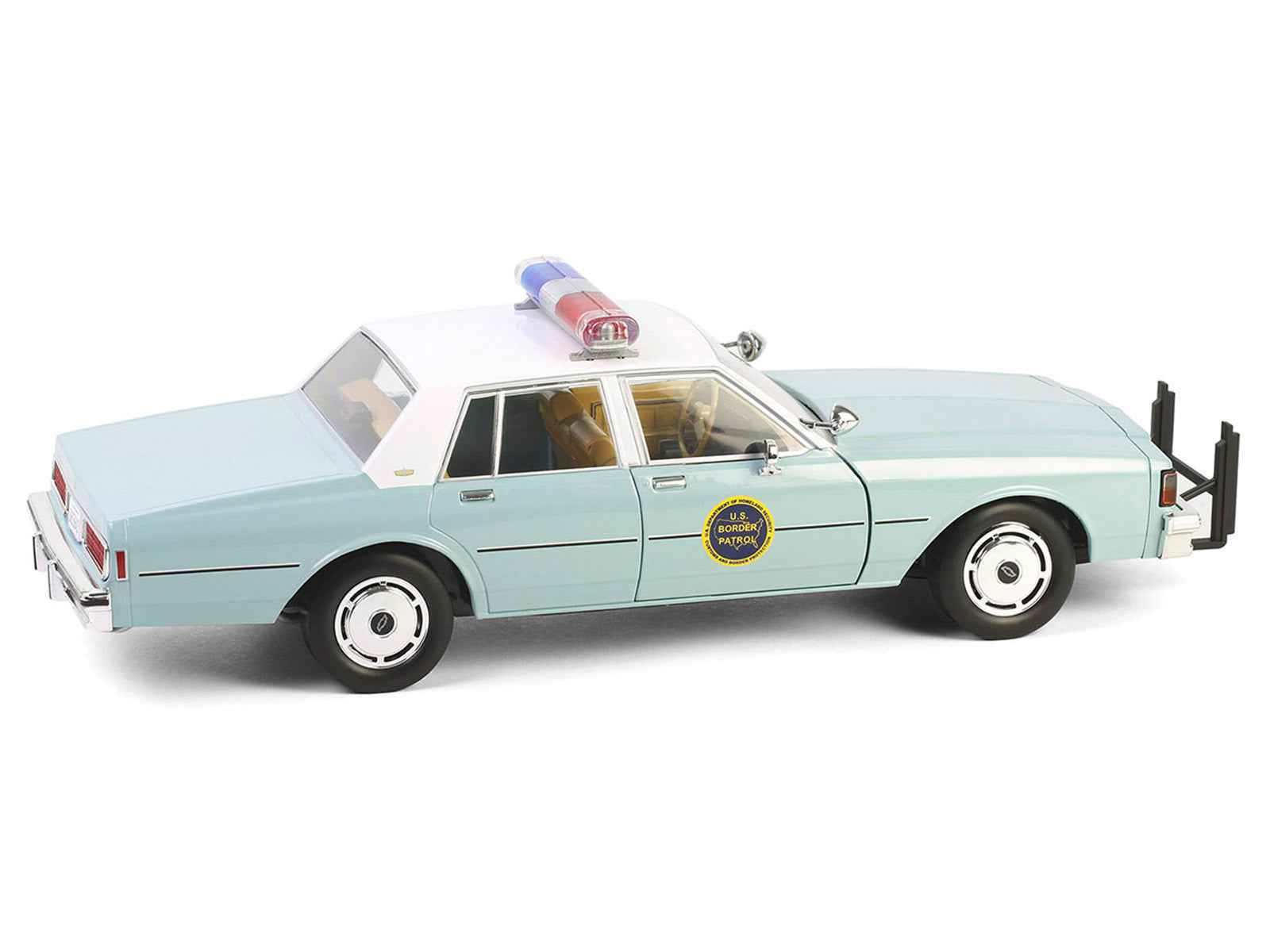 Angled view of light green 1:18 diecast police sedan with white top and front push bar