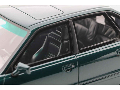 Emerald green metallic die-cast model car with door, window, and dark interior seats