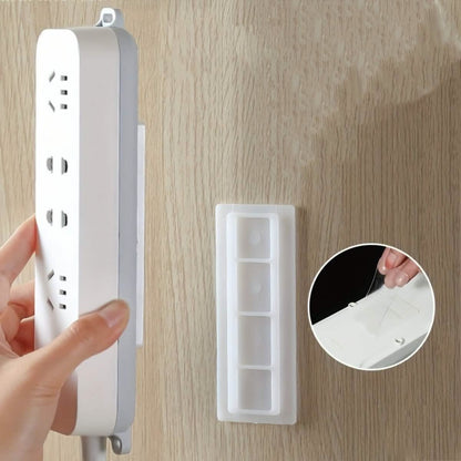 White wall surge protector organizer panel and separate mounting base on wood