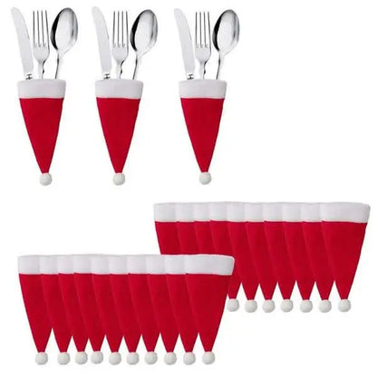 Red and white Santa hat utensil holders with silverware and pom-poms