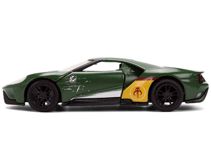 Green diecast Ford GT model car, side profile with red stripe and yellow circular emblem