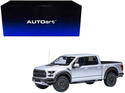 1/18 scale Ford F-150 Raptor pickup model car, silver, front 3/4 view with off-road tires