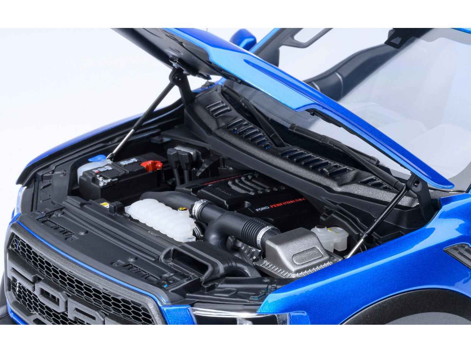 Autoart 1/18 blue Ford F-150 Raptor model car, open hood showing engine bay