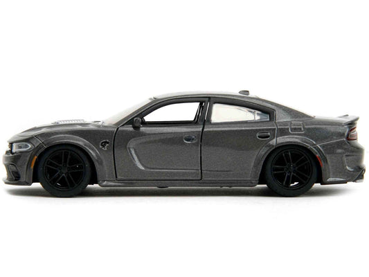 Gray die-cast sports car model, side view with black wheels and tinted windows