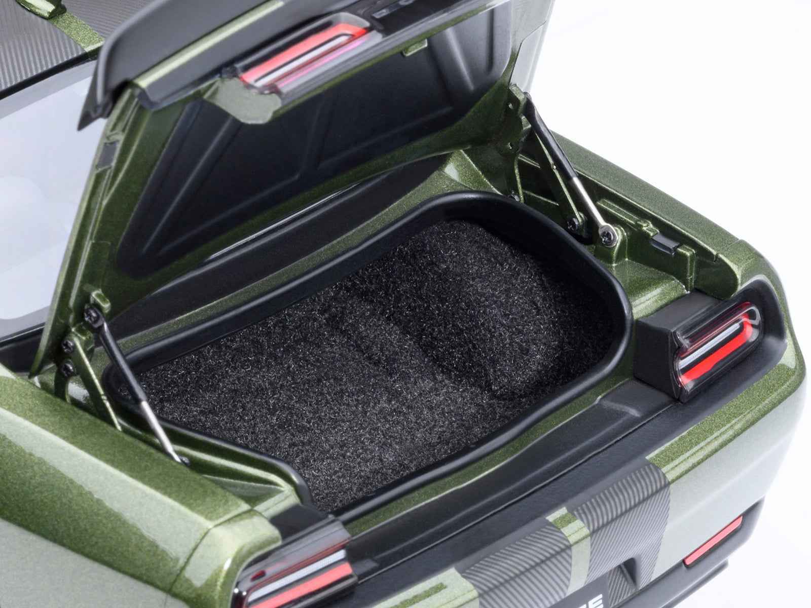 Open rear trunk of green 1:18 Challenger model car with black cargo mat