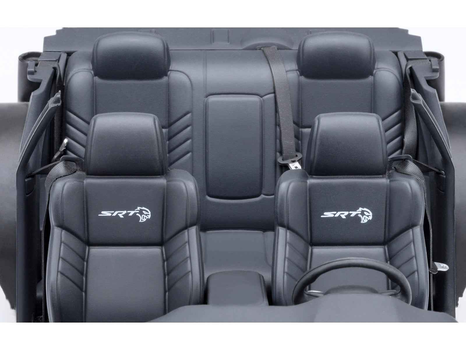 Die-cast model car interior with black front seats and steering wheel detail