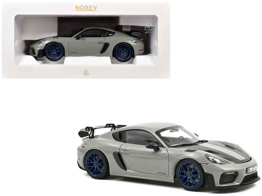 Chalk gray diecast sports car model with carbon hood stripes and blue wheels