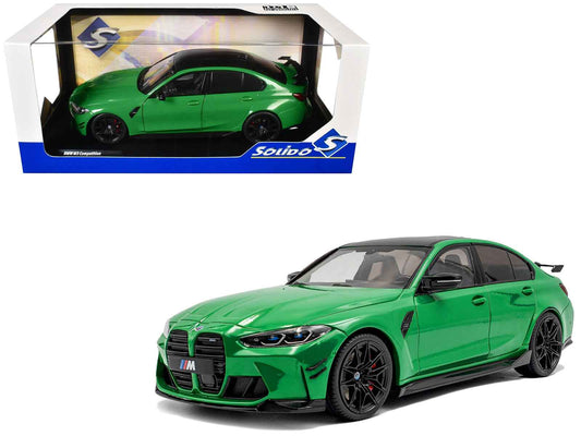 Green diecast model car in display box, black wheels, front three-quarter view
