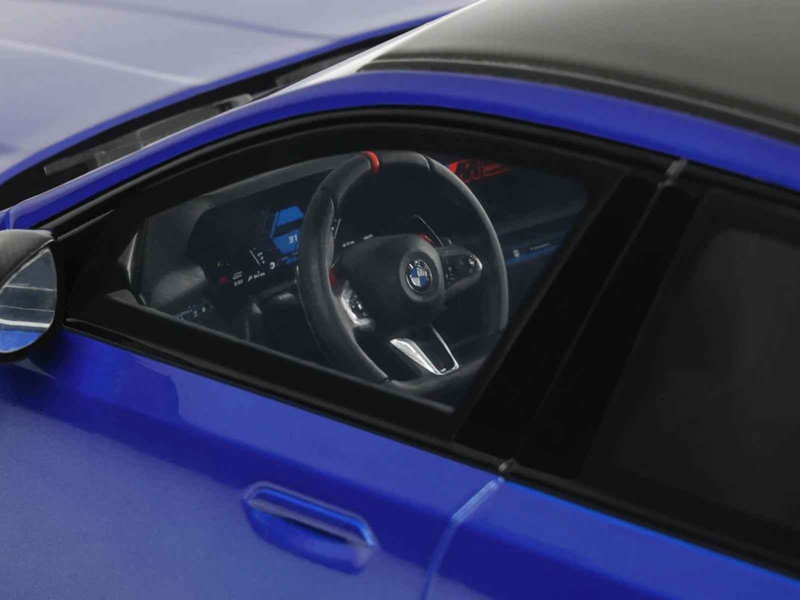 Blue BMW M5 model car interior with steering wheel and dashboard detail