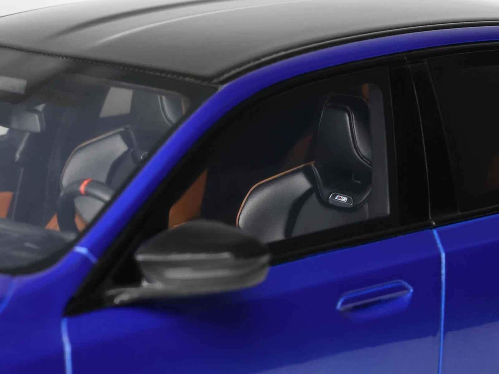 Blue BMW M5 model car window and black-trim door area, close-up