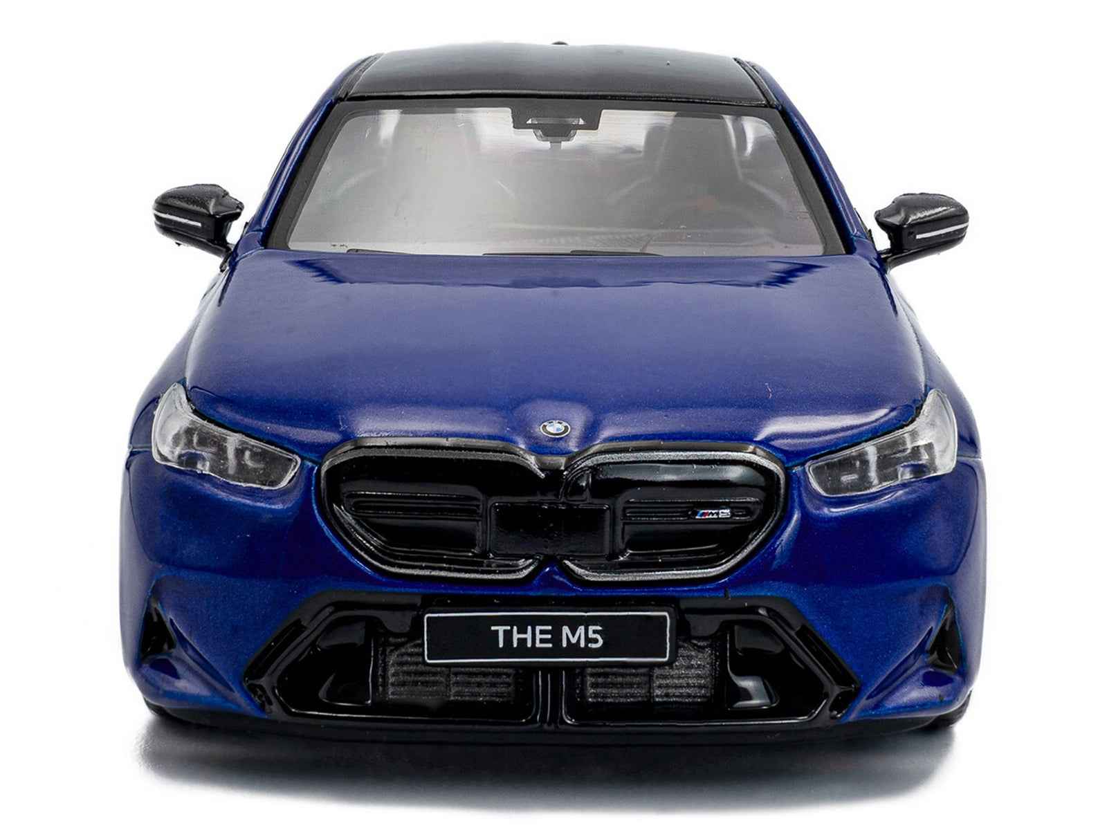 Diecast BMW M5 sedan model car in marina blue with black roof, front view.