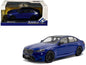 Diecast BMW M5 sedan model car, marina blue body with black roof, in display box.