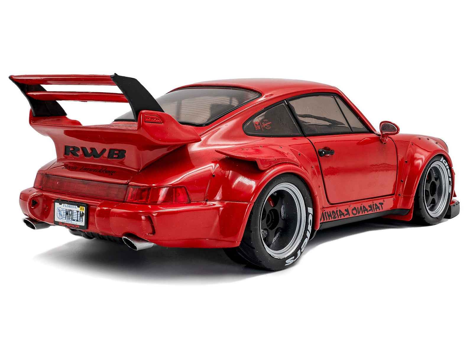Red 1/18 diecast sports car model with black stripes, rear wing and diffuser