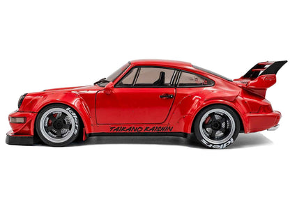 Red 1/18 diecast sports car model with black side stripes and rear spoiler