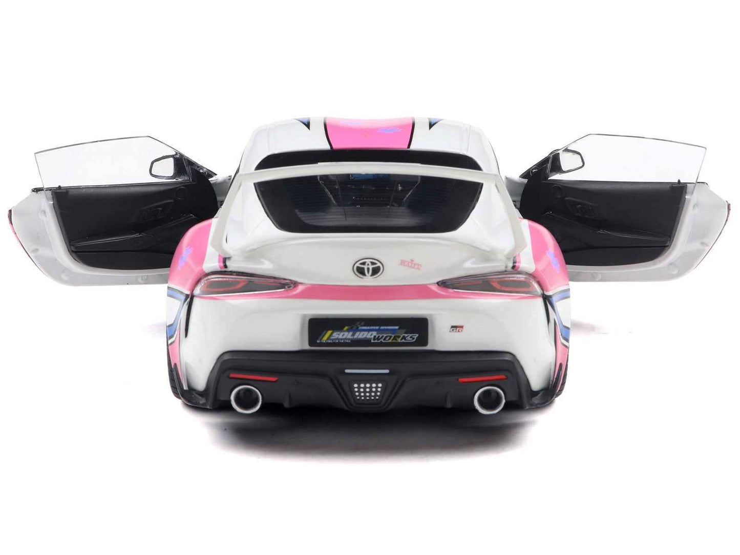 White diecast sports car model with pink graphic rear view, doors open