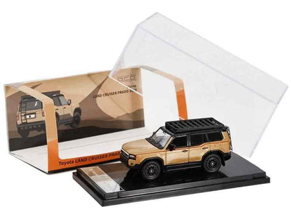 Gold diecast SUV model car with black roof rack and dark wheels, in display box