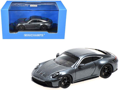 Metallic gray 1/64 diecast Porsche-style sports car model in blue MINICHAMPS box