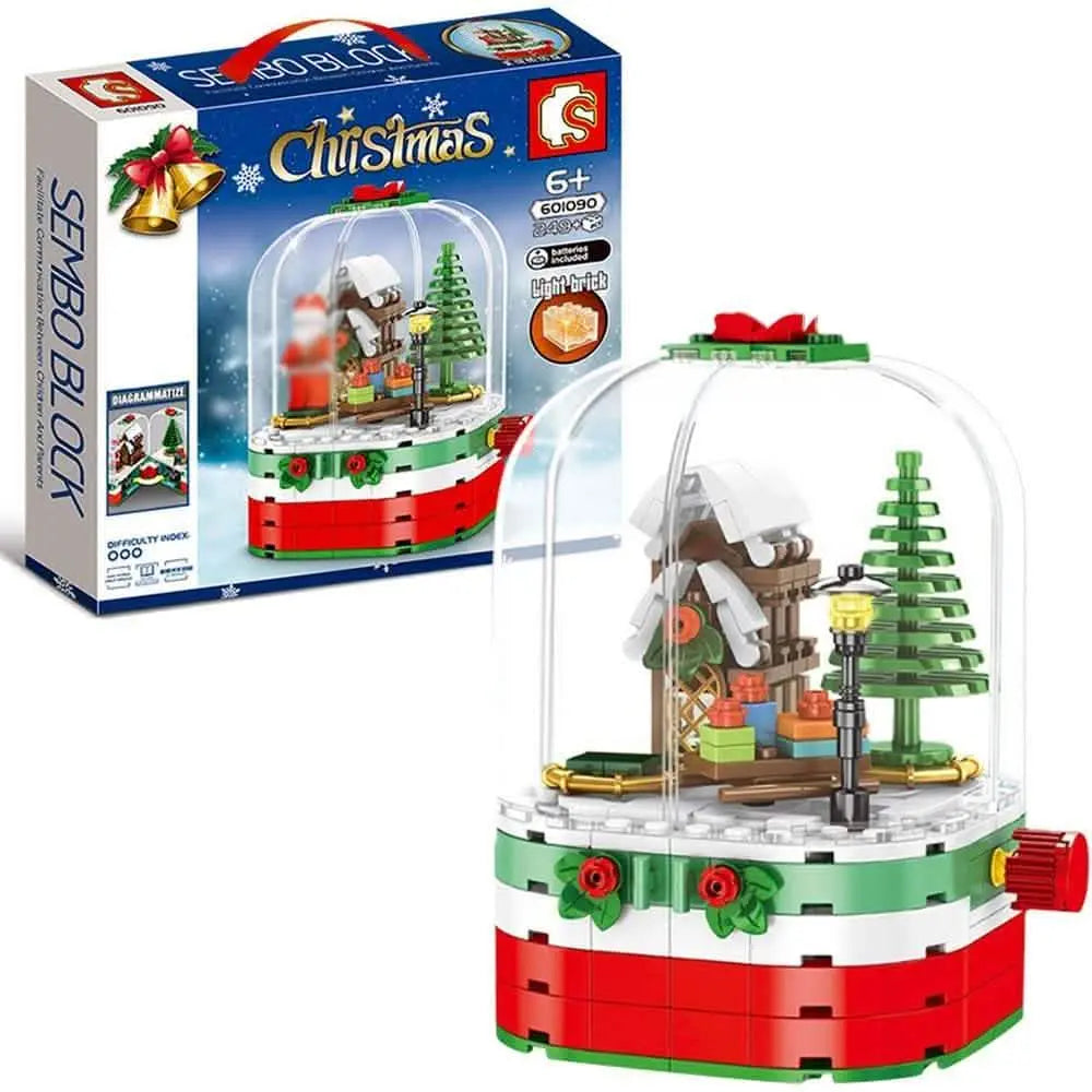 Christmas rotating light-up building blocks set in a clear dome, cabin and tree