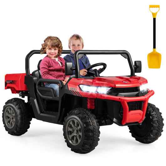 Red 24V kids ride-on dump car with black wheels, steering wheel, and front headlights