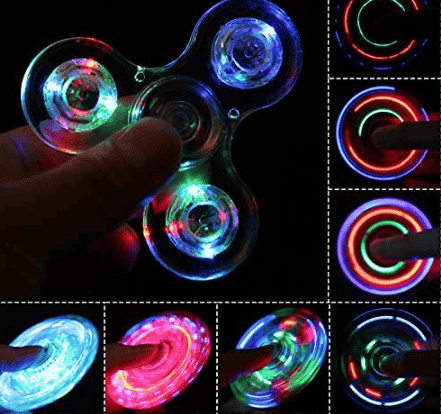 Blue LED fidget spinner with finger near the center and rainbow glow