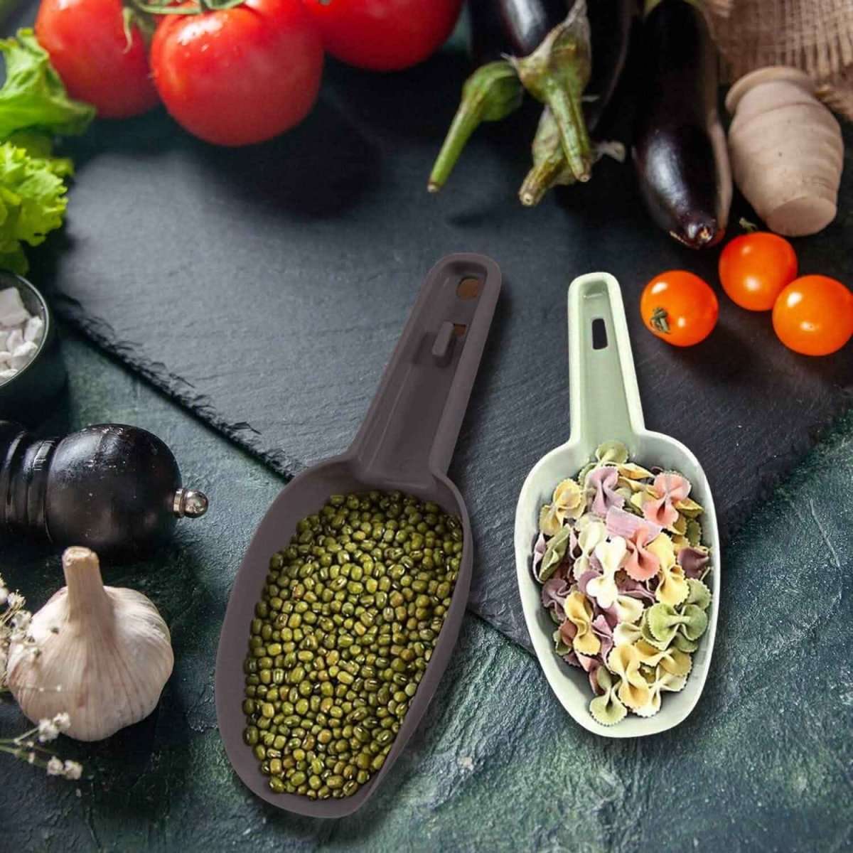 3-piece plastic scoop set holding green peas and pasta in beige and purple scoops.