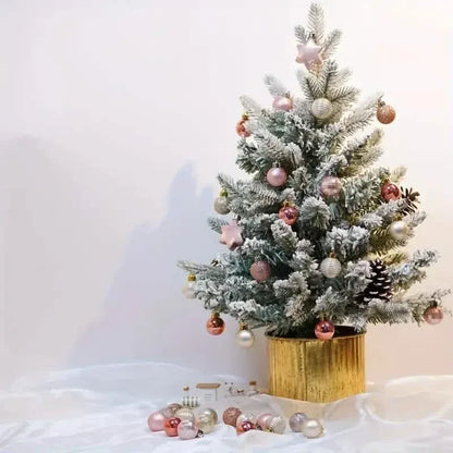 Frosted Christmas tree with pink and rose bauble decorations and a star topper