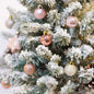 Pink glitter star tree topper with hanging baubles on a decorated Christmas tree