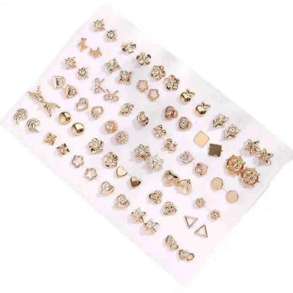 Gold-tone stud earrings set on white card with hearts, flowers, and geometric pieces