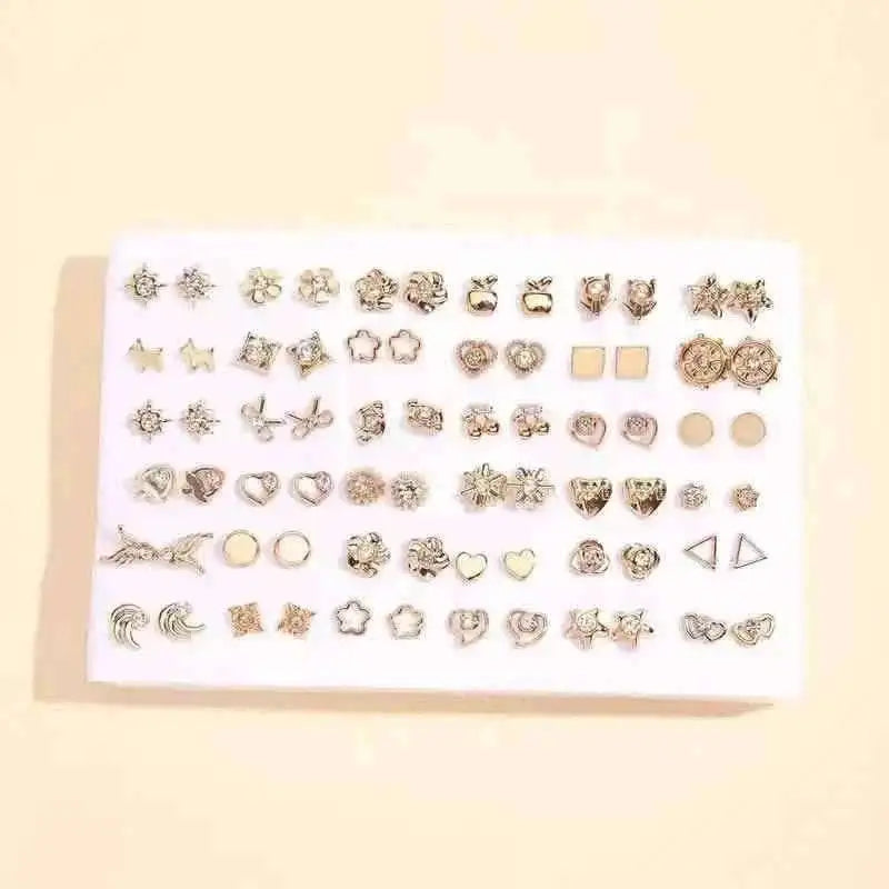 Silver-tone stud earrings set on white card with stars, hearts, and geometric shapes