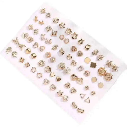 Gold-tone stud earrings set on white card with hearts, flowers, and geometric pieces