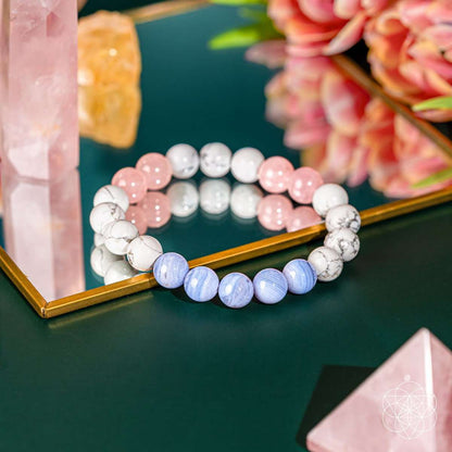 Pair of beaded bracelets with pink, white, and light blue stone beads on a tray