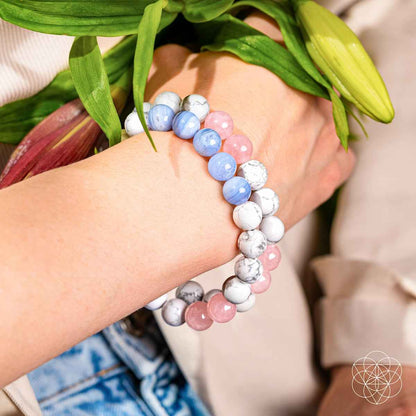 Triple bracelet stack on arm with pink, white, and light blue stone beads