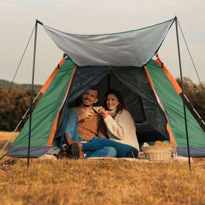 Green 4-5 person camping tent with overhang; two people sitting inside under the canopy.